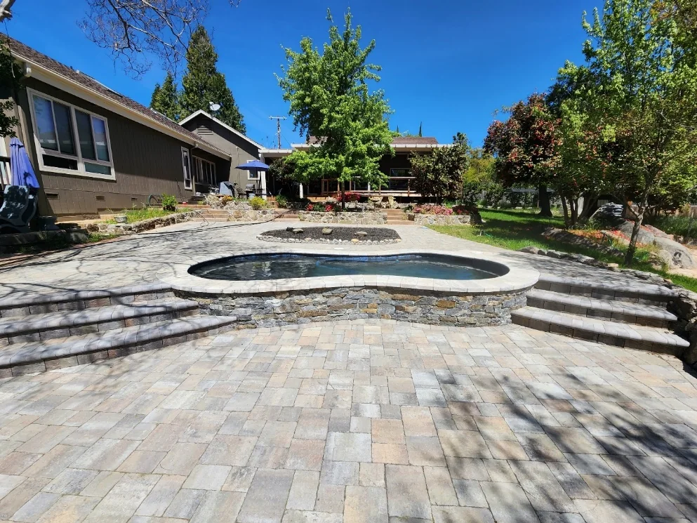 Finished pool with retaining walls and terraced hardscape