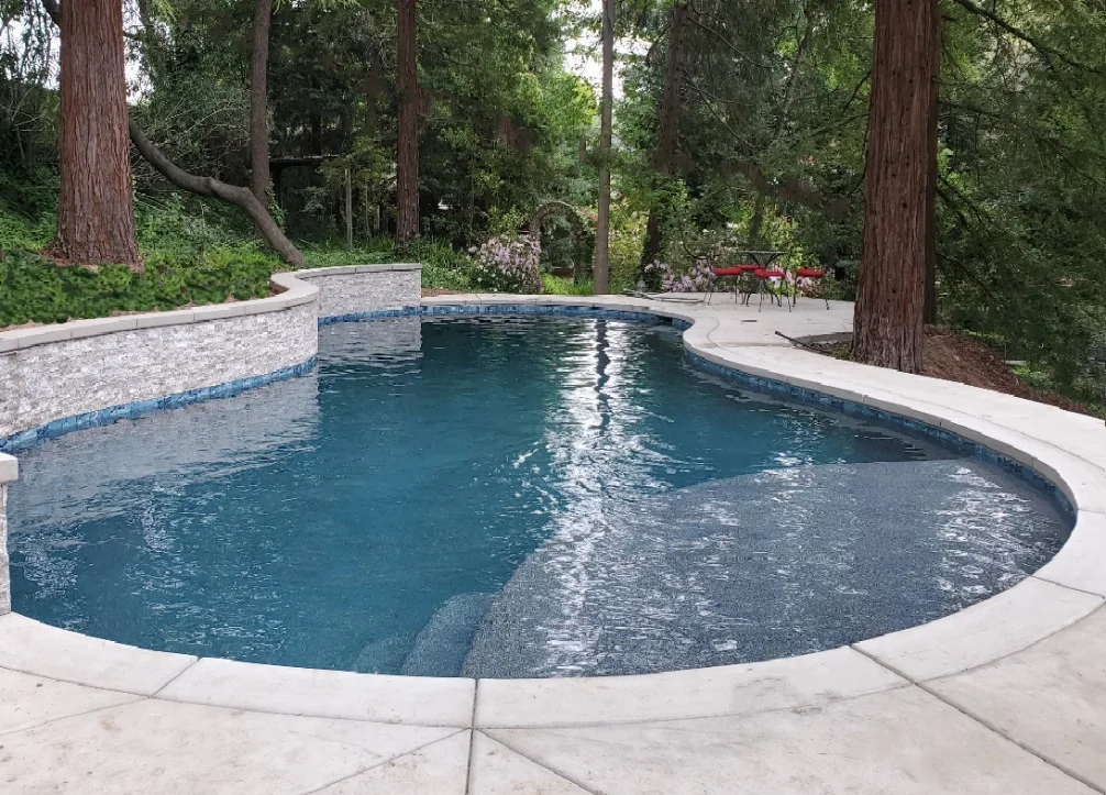 Finished raised pool surrounded by mature trees