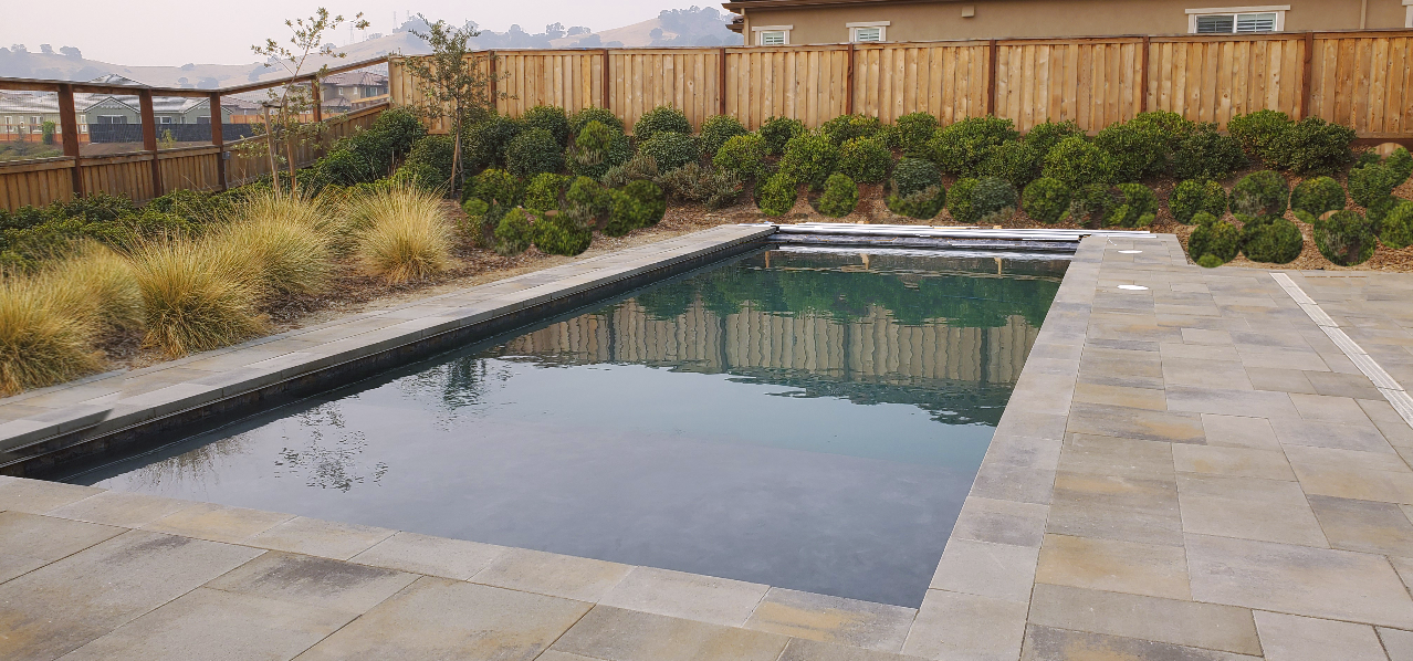 Rectangular shaped pool with automatic pool cover.