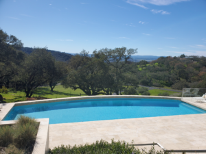 Residential pool on a sloped lot with a view of the hills in Northern California