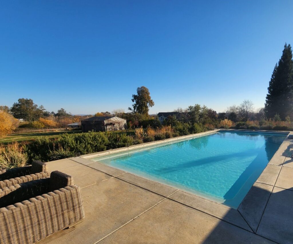 A rectangular shaped pool with an automatic pool cover