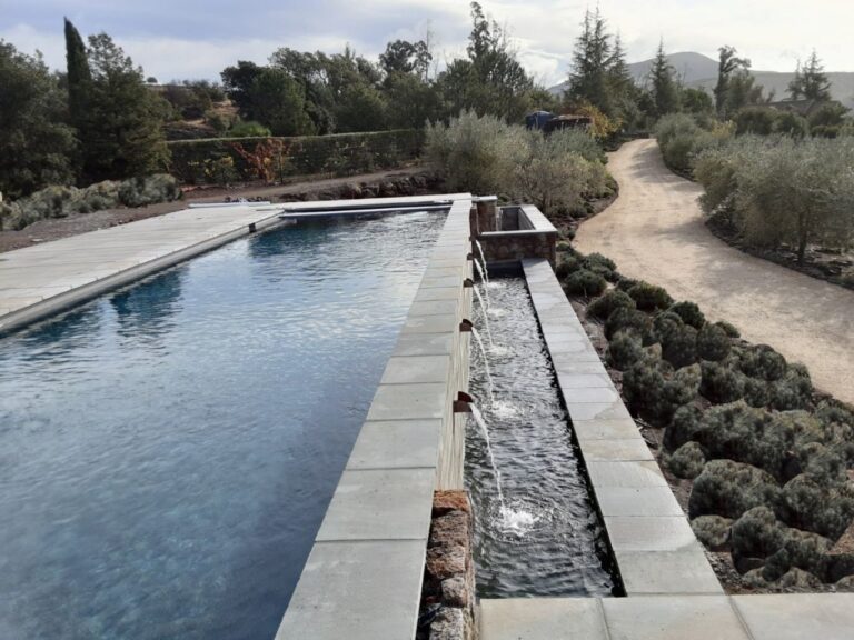 Rectangular pool in Napa County with an automatic pool cover and scupper water features.