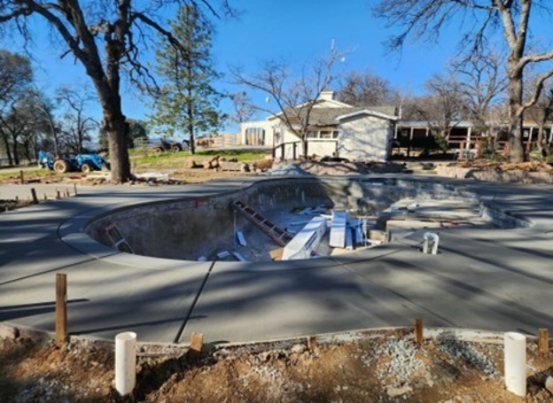 A large freeform pool and spa under construction in Nevada County.