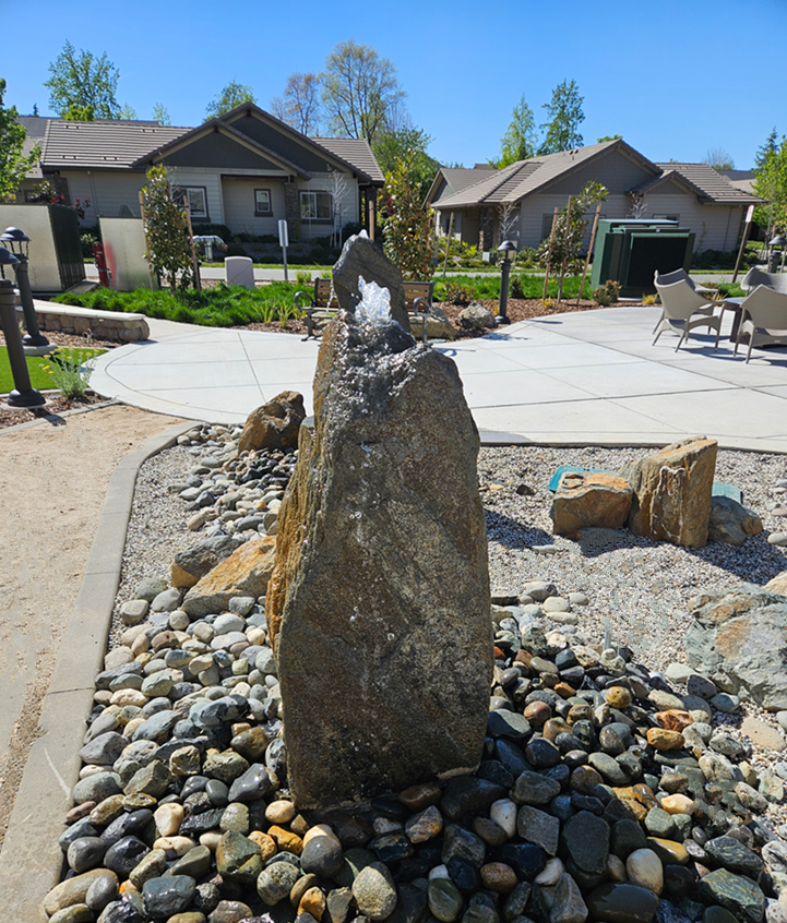 Close up of a boulder rock fountain custom built for senior living apartments in Auburn, Califoria